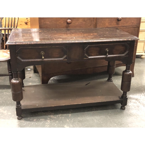 681 - An oak side table in 17th century style, two geometric drawers, on turned supports with undershelf, ... 