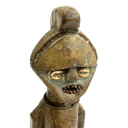 263 - A large colonial period copper clad West African power figure, having cowrie shell eyes, metal teeth... 