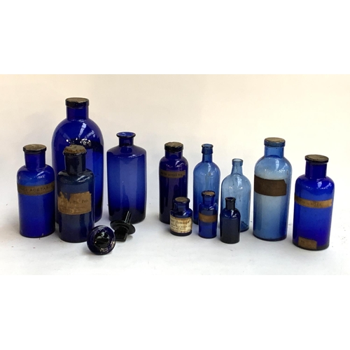 140 - Twelve blue glass drug bottles, the largest 27cmH