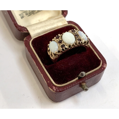 4 - A heavy 9ct gold ring set with opals and garnets, size M 1/2, approx. 6.3g, in an antique ring box