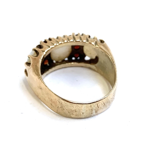 4 - A heavy 9ct gold ring set with opals and garnets, size M 1/2, approx. 6.3g, in an antique ring box