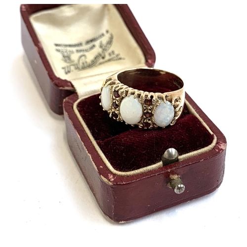 4 - A heavy 9ct gold ring set with opals and garnets, size M 1/2, approx. 6.3g, in an antique ring box