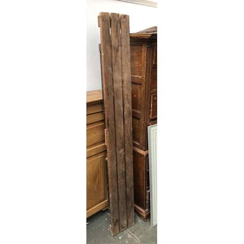 769 - A vintage slatted pine trestle bench, 181cmL