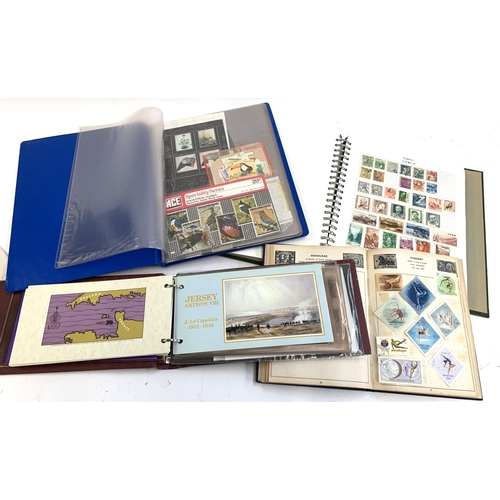 147 - Two stamp albums containing British and World stamps, together with an album of Jersey presentation ... 