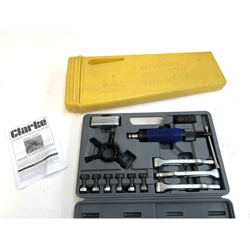 299 - A cased Clarke hydraulic puller set, together with an AA warning triangle