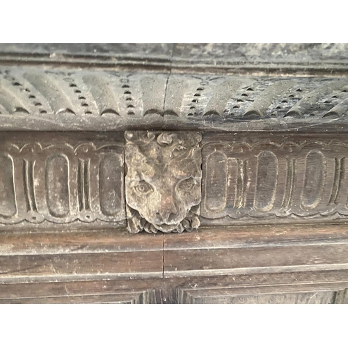 661 - Two oak panelled and carved fire places, each with central lion mask detail, each 153cmW