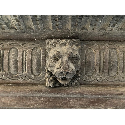 661 - Two oak panelled and carved fire places, each with central lion mask detail, each 153cmW