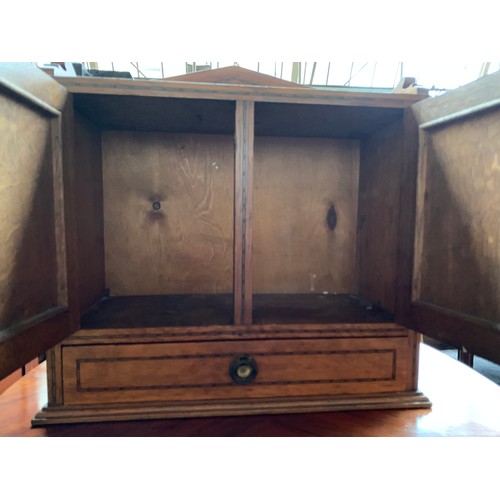 606 - An early 20th century oak medicine cabinet, two panelled doors with single drawer below, 51x21x51cmH