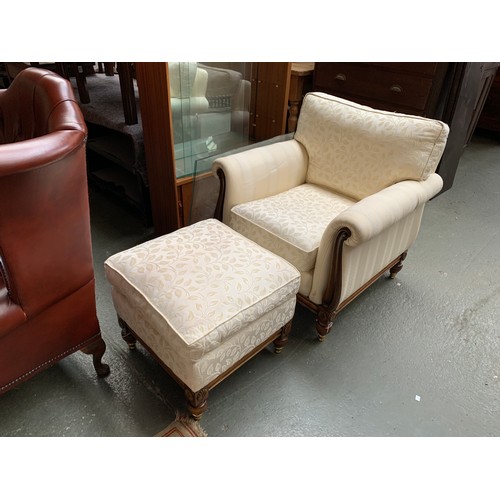 646 - A beech armchair and foot stool of recent manufacture, upholstered in cream stripe woven fabric, the... 