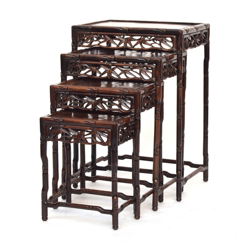 644 - An early 20th century Chinese hardwood quartetto nest of tables, with pierced carved bamboo leaf fri... 