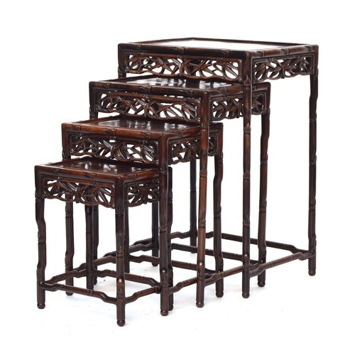 644 - An early 20th century Chinese hardwood quartetto nest of tables, with pierced carved bamboo leaf fri... 