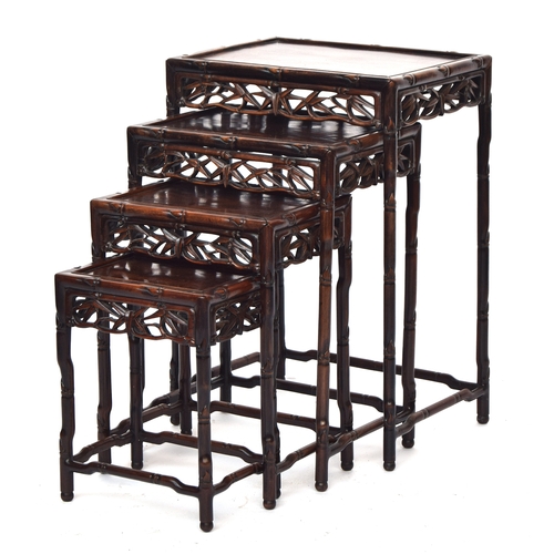 644 - An early 20th century Chinese hardwood quartetto nest of tables, with pierced carved bamboo leaf fri... 