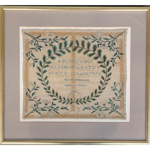 229 - A Georgian needlework alphabet sampler, with wreath and floral decoration, worked by Sarah Thompson,... 