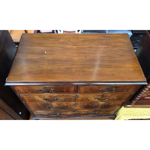 672 - An 18th century and later walnut chest of two short over three graduating drawers, the drawers feath... 