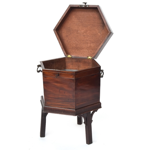 548 - A 19th century mahogany hexagonal cellarette, with divided interior, twin brass handles, and square ... 