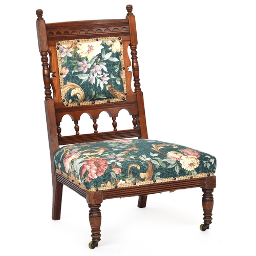 618 - A late 19th century mahogany framed nursing chair by Gillows of Lancaster, on turned front legs with... 