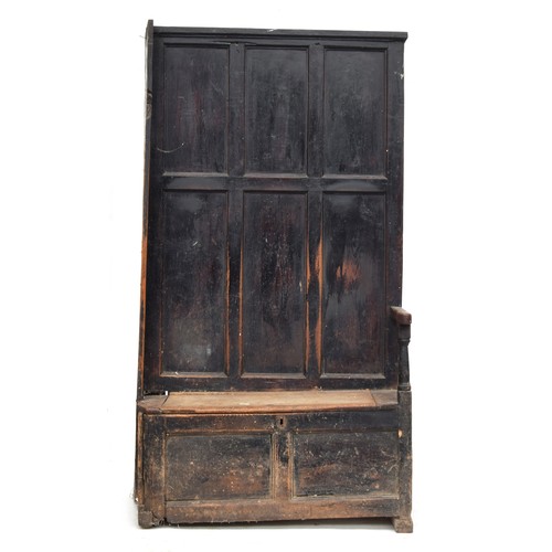 468 - A provincial 18th century and later panelled hall settle and bacon cupboard, the seat with hinged li... 