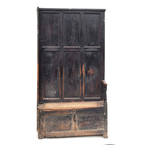 468 - A provincial 18th century and later panelled hall settle and bacon cupboard, the seat with hinged li... 