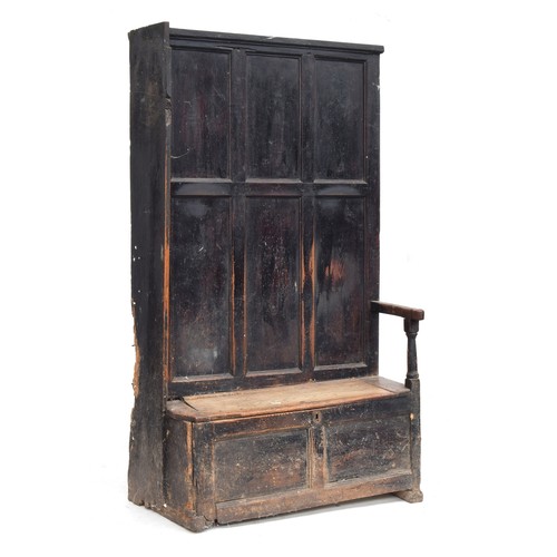 468 - A provincial 18th century and later panelled hall settle and bacon cupboard, the seat with hinged li... 