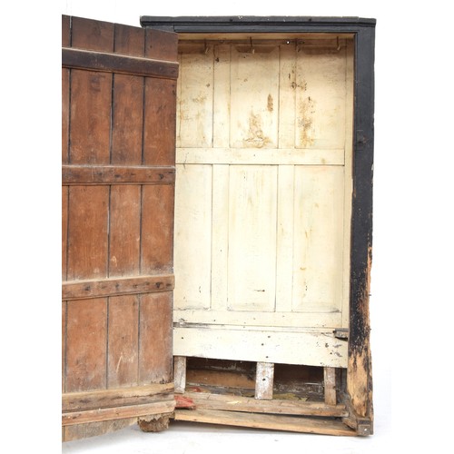 468 - A provincial 18th century and later panelled hall settle and bacon cupboard, the seat with hinged li... 