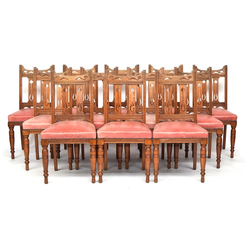 594 - A good set of 14 early 20th century Arts & Crafts oak dining chairs, Liberty style, two carvers, eac... 