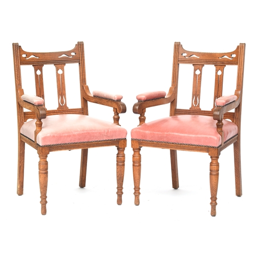 594 - A good set of 14 early 20th century Arts & Crafts oak dining chairs, Liberty style, two carvers, eac... 