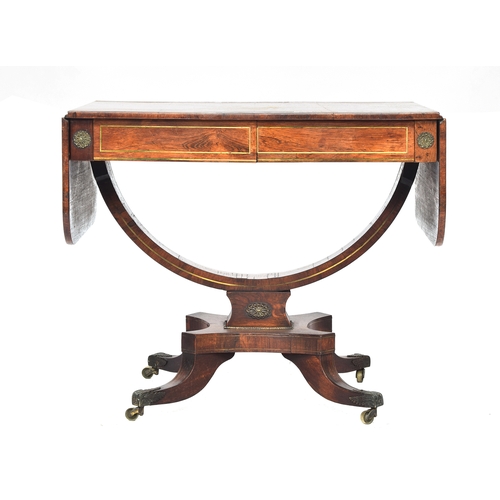 566 - A Regency rosewood and brass inlaid sofa table, with two frieze drawers, on a semicircular stretcher... 