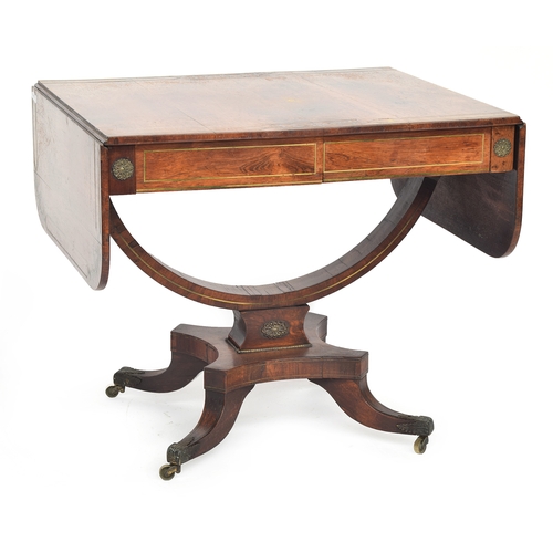 566 - A Regency rosewood and brass inlaid sofa table, with two frieze drawers, on a semicircular stretcher... 