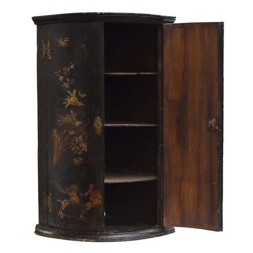 501 - A George III Japanned bowfront corner cupboard, the doors depicting pagodas and foliage, opening to ... 