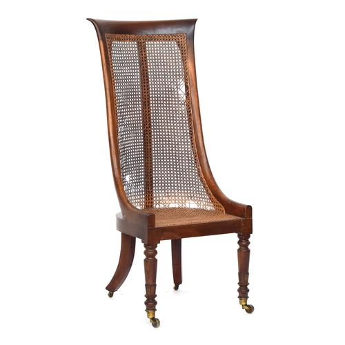 616 - A Regency mahogany caned bergère tub chair, with an unusually high back, caned seat with squab cushi... 