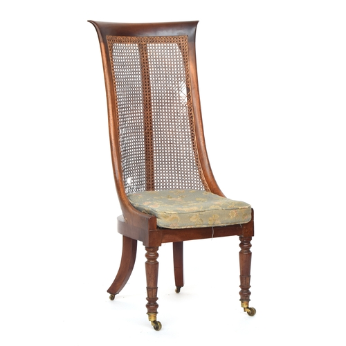 616 - A Regency mahogany caned bergère tub chair, with an unusually high back, caned seat with squab cushi... 