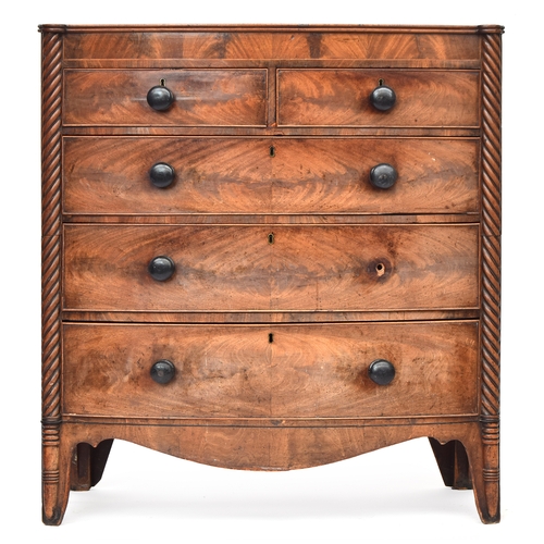 490 - A Regency mahogany bowfront chest of two short over three graduating drawers, flanked by spiralled c... 