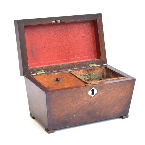 184 - A Regency mahogany sarcophagus tea caddy, the lid with central gadrooned tablet