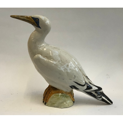 82 - An Italian studio pottery bird (af), 35cmH; together with a carved wooden duck (2)