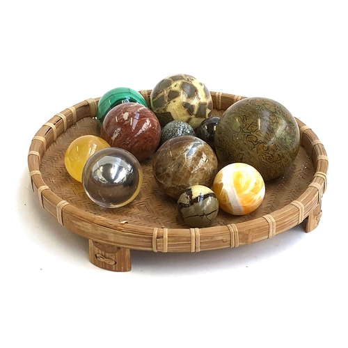 197 - A collection of 13 mineral and other orbs, to include malachite, quartz etc, within a wicker basket