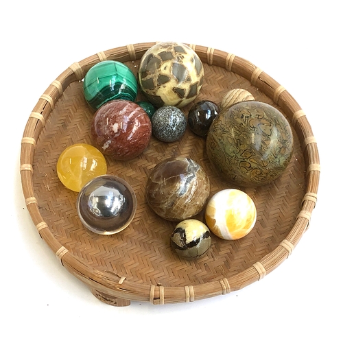 197 - A collection of 13 mineral and other orbs, to include malachite, quartz etc, within a wicker basket