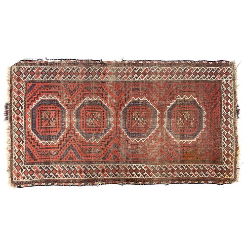 664 - A small Persian rug, four octagonal medallions on a red ground, 85x156cm