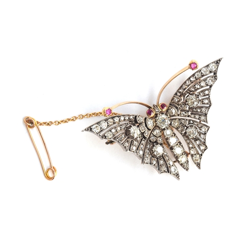 13 - An exquisite Victorian diamond butterfly brooch, set in gold and silver with ruby eyes and antennae,... 