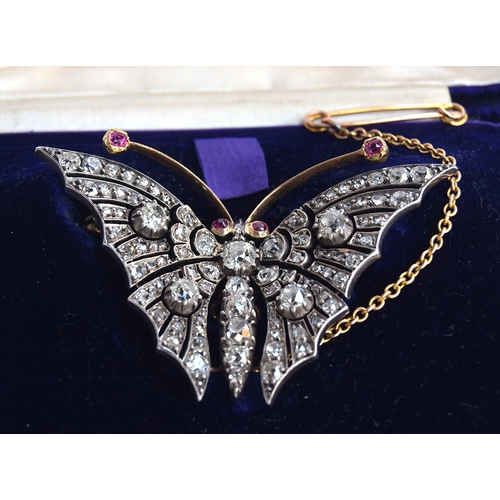 13 - An exquisite Victorian diamond butterfly brooch, set in gold and silver with ruby eyes and antennae,... 