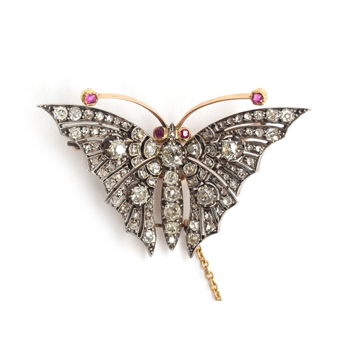 13 - An exquisite Victorian diamond butterfly brooch, set in gold and silver with ruby eyes and antennae,... 