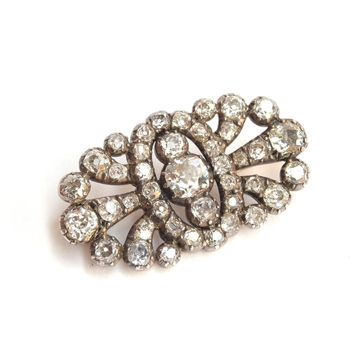 12 - A Victorian diamond brooch of openwork form, set with 41 old cut diamonds in pinched collet settings... 