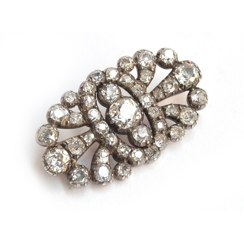 12 - A Victorian diamond brooch of openwork form, set with 41 old cut diamonds in pinched collet settings... 