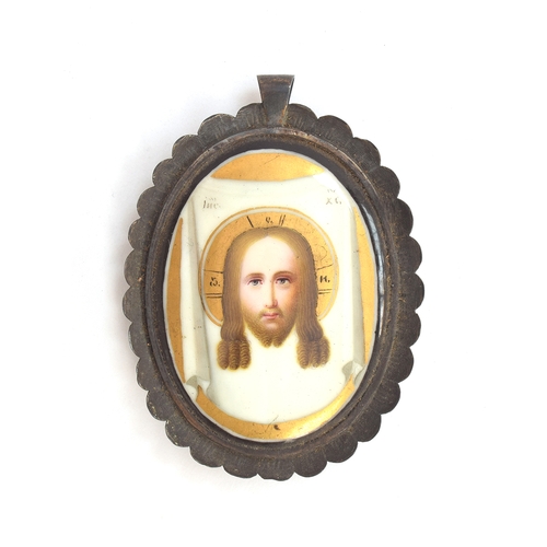 98 - A 19th century Russian Orthodox hand painted porcelain pendant set in a scalloped white metal frame,... 