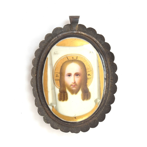 98 - A 19th century Russian Orthodox hand painted porcelain pendant set in a scalloped white metal frame,... 