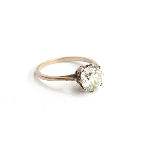 3 - An early 20th century white gold solitaire ring set with a white zircon, approx. 1.5ct, size J 1/2, ... 