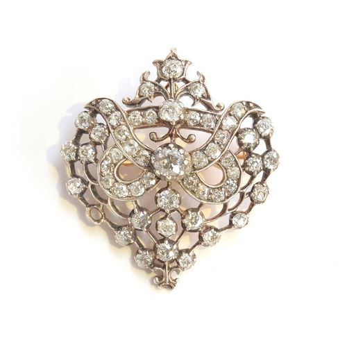 19 - A Belle Epoque gold, silver and diamond set openwork pendant brooch, set with 51 old cut diamonds (o... 