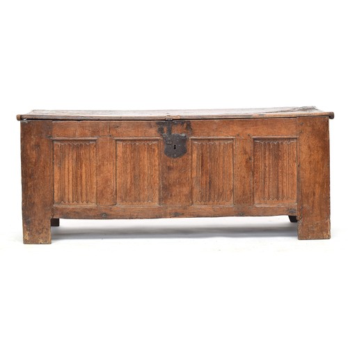 451 - A large 16th century Flemish oak coffer, the planked lid above a four panel linen fold carved front,... 