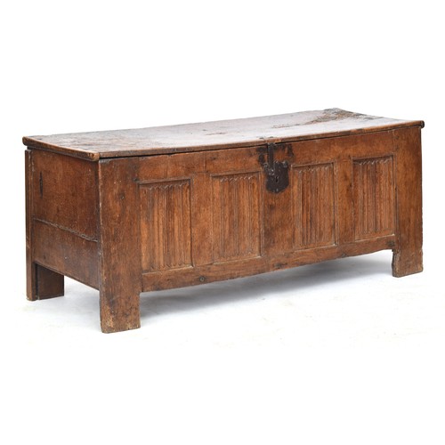 451 - A large 16th century Flemish oak coffer, the planked lid above a four panel linen fold carved front,... 