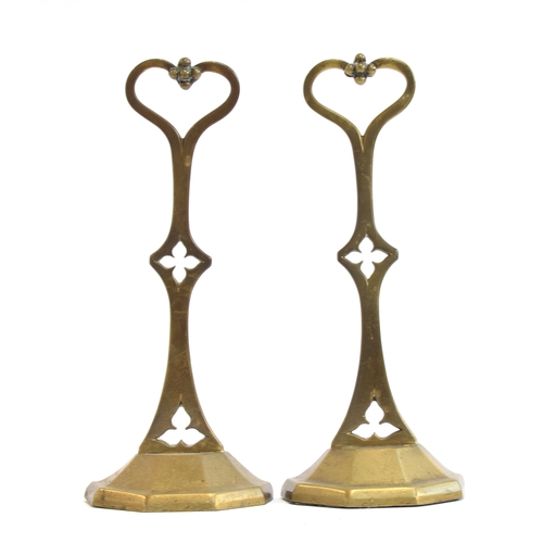 424 - A pair of late Victorian brass doorstops with trefoil and quatrefoil cutouts and heart shaped handle... 