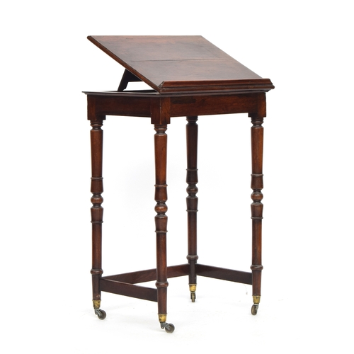 544 - A late Regency rosewood reading table, hinged reading slope, on turned supports, with brass caps and... 